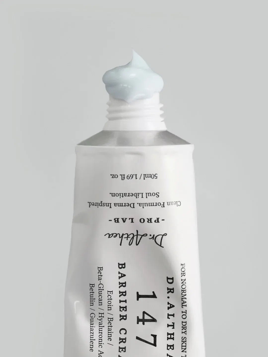 A squeeze tube of Dr. Althea 147 Barrier Cream 50ml with a dollop of pale blue cream on top, set against a solid light gray background.