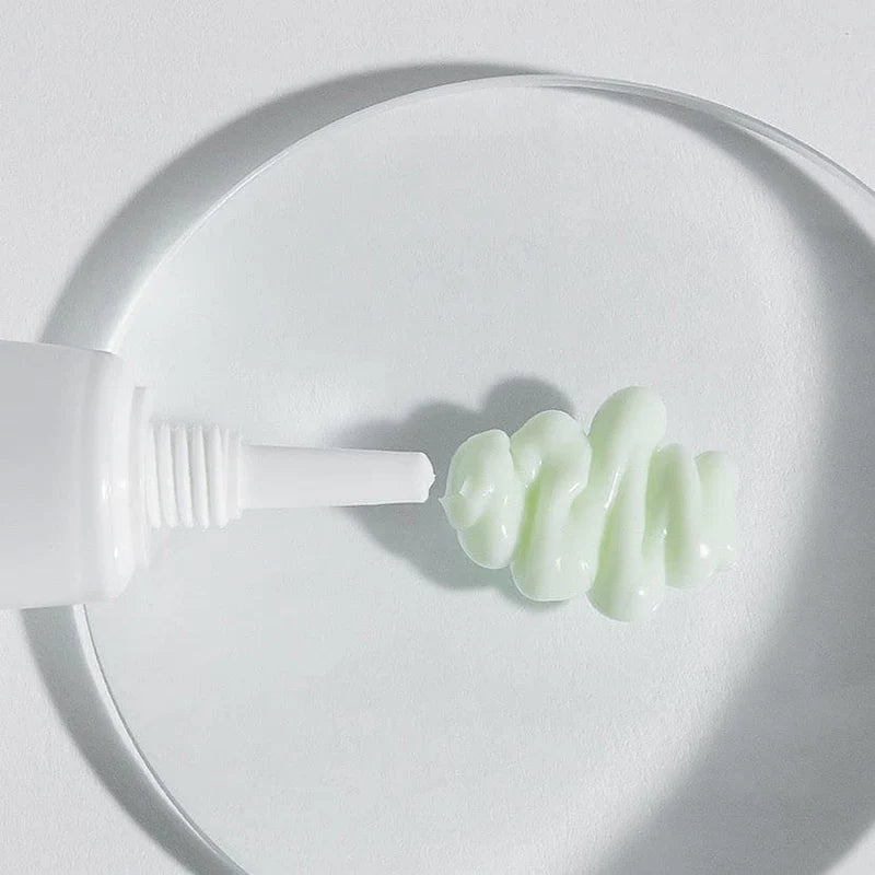 Close-up of a white plastic tool with a green substance on a white background