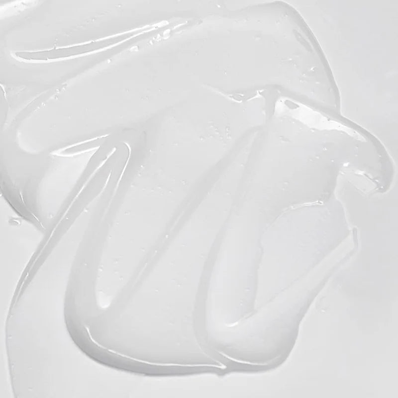 Close-up of white gelatinous material on a light gray background