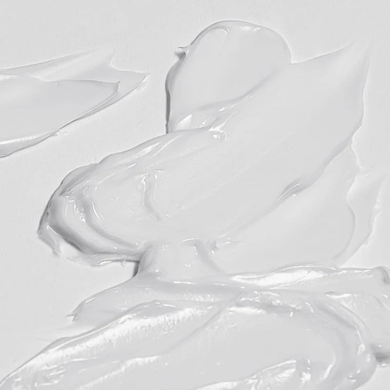 Close-up of glossy white paint texture on a light gray background