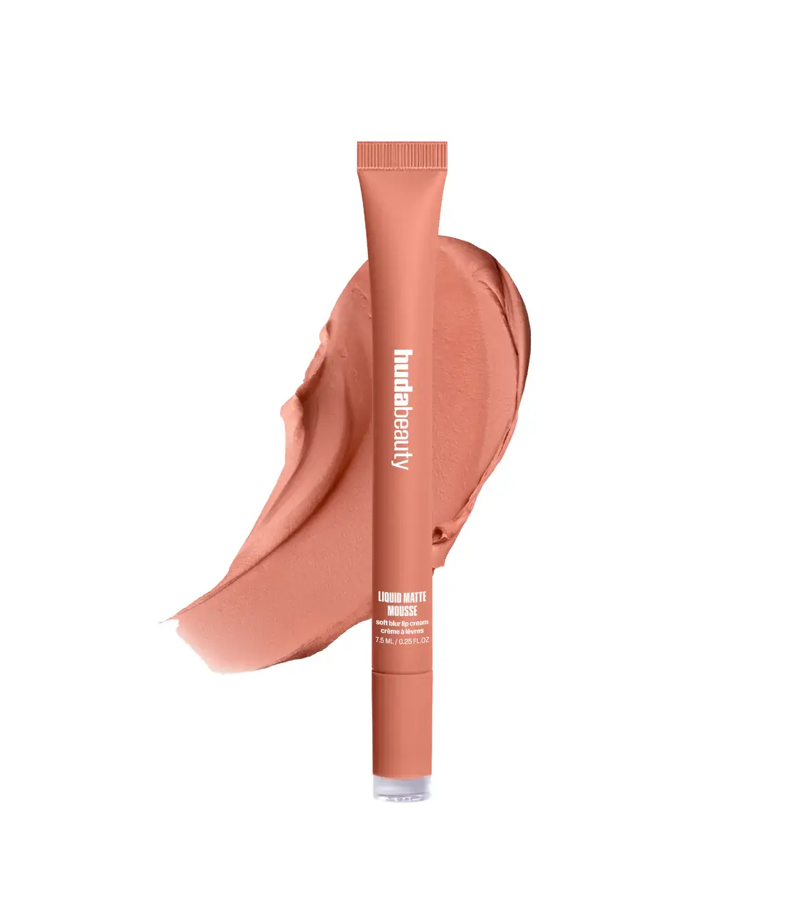 A nude peach makeup stick by Huda Beauty, shown upright with a matching smear of the product behind it on a clean white background.