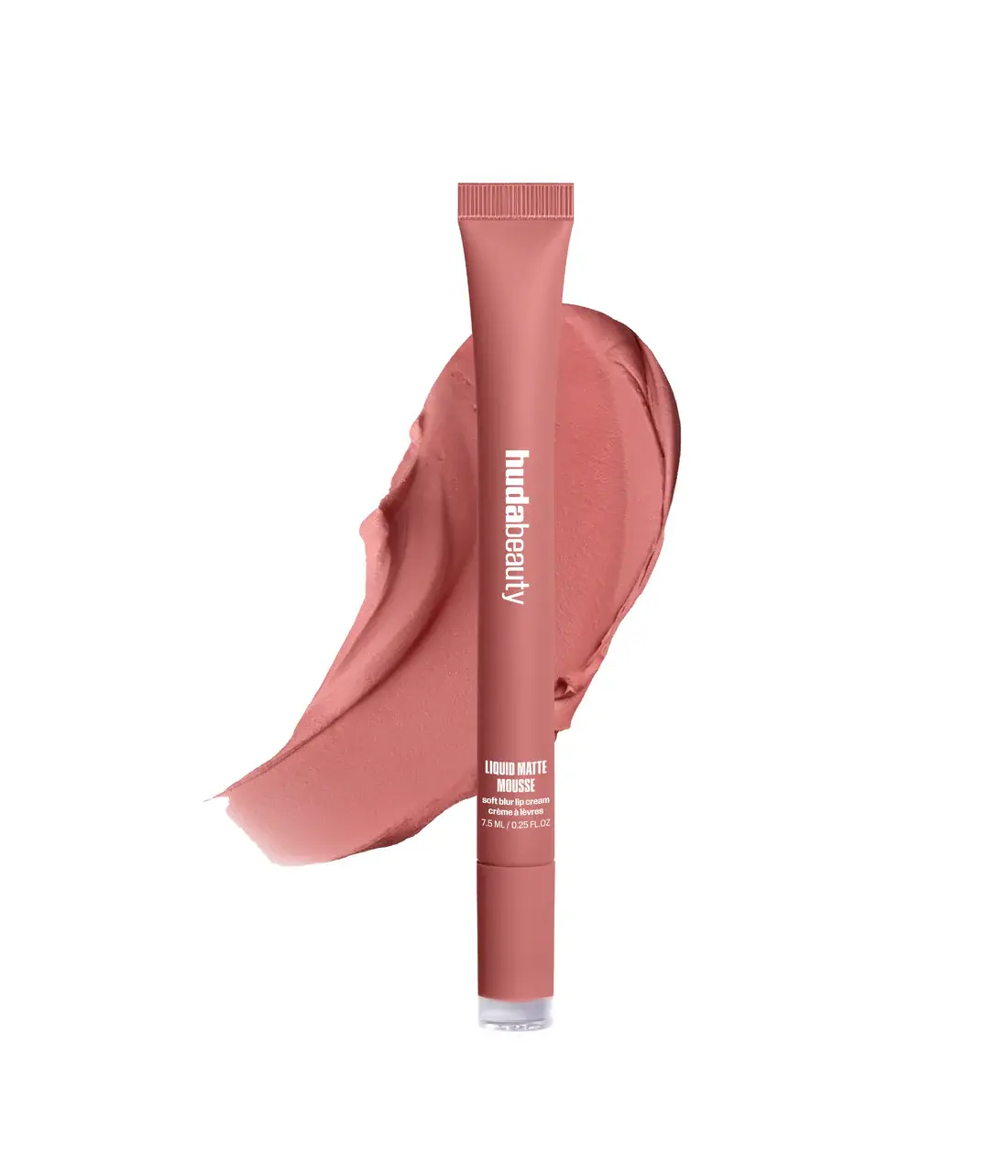 A tube of Huda Beauty Liquid Matte Mousse in a dusty rose pink shade, shown upright with a matching powder smear behind it on a white background.