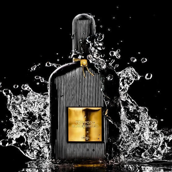 Perfume bottle with water splashes on a black background